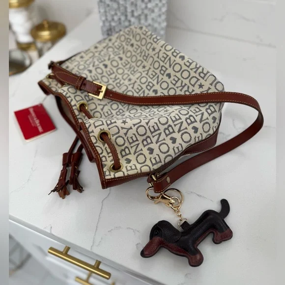 Dooney & Bourke Ivory and Brown Bucket Bag with Dachshund Leather Charm
